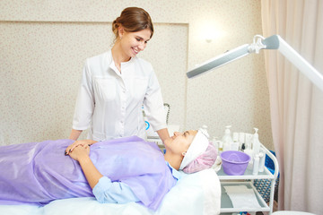 Girl beautician works with patients in the office