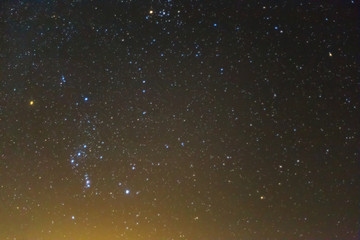 orion constellation on a night starry sky background