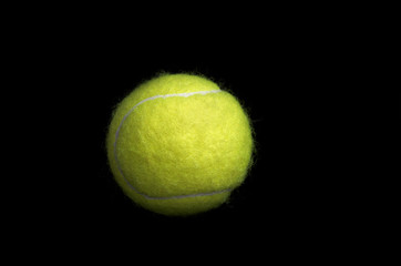 Tennis ball isolated on black background.
