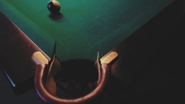 American billiard. Man playing billiard, snooker. Player preparing to shoot, hitting the cue ball.