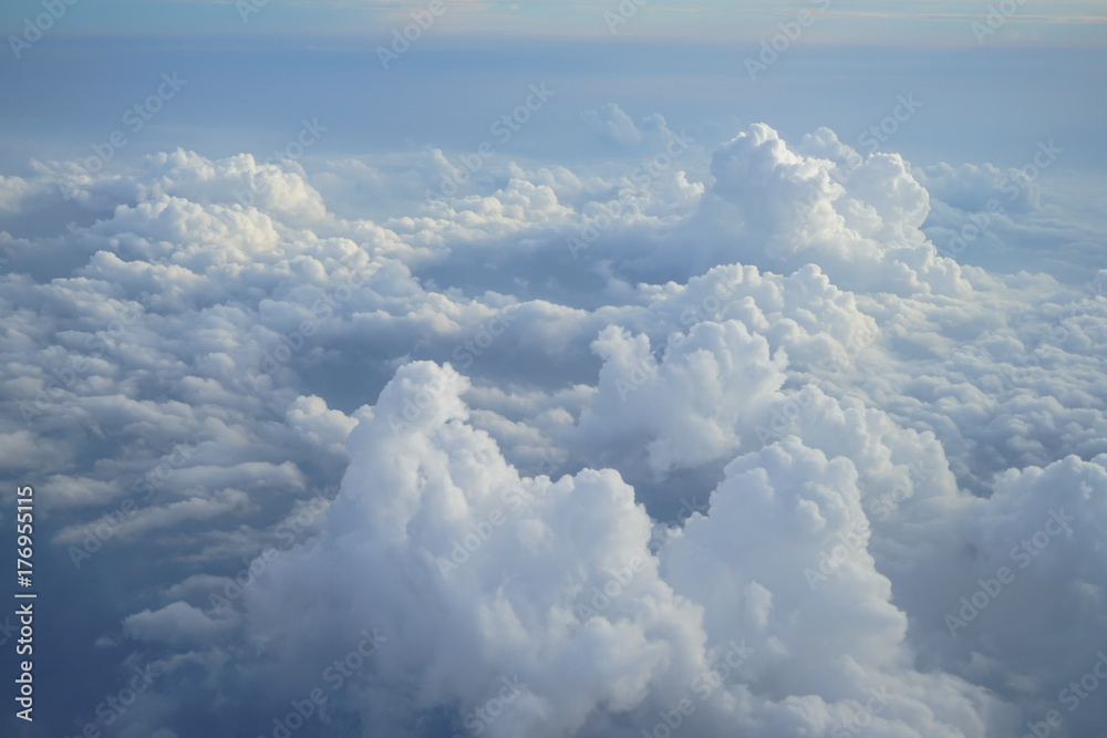 Wall mural view of beautiful heaven cloudscape with shades of blue sky background from flying plane window