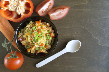 bulgur with vegetables on wooden background