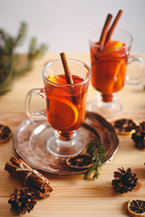 Beautiful Christmas background with mulled wine in a glass, gingerbread and New Year decor