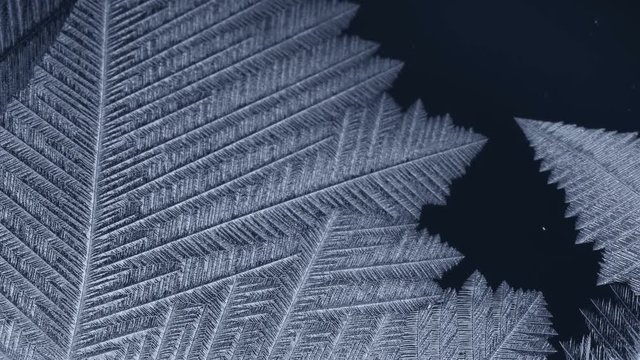 Freezing window close-up, winter holidays background,