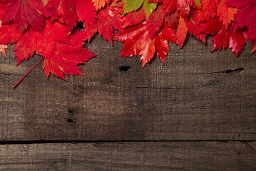 Naklejka na ściany i meble Autumn leaves and plaid on old vintage wooden background.