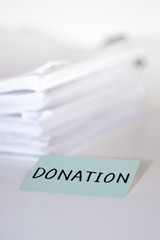 Donation; Stack of Documents on white desk and Background.