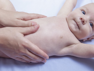 Fototapeta na wymiar Three month baby boy abdomen massage
