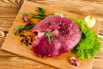 meat on the board before cooking top view, horizontal frame