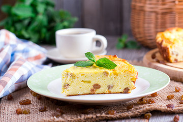Cottage cheese casserole with raisins and semolina on wooden background Cottage cheese casserole