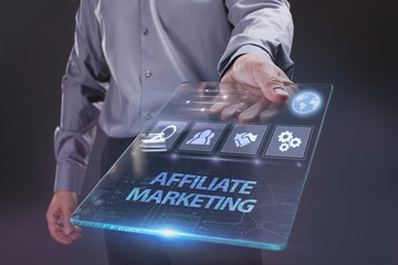 The concept of business, technology, the Internet and the network. A young entrepreneur working on a virtual screen of the future and sees the inscription: Affiliate marketing