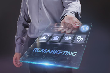 The concept of business, technology, the Internet and the network. A young entrepreneur working on a virtual screen of the future and sees the inscription: Remarketing