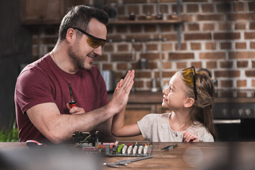 Father giving high five to daughter