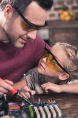 Father teaching daughter to braze