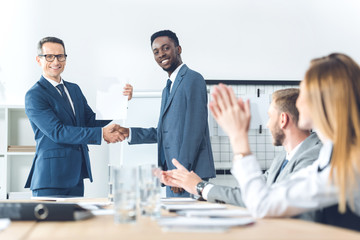 boss shaking hand of manager