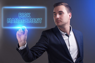 The concept of business, technology, the Internet and the network. Young businessman showing inscription: Risk management