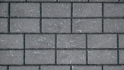 European bulimnik gray, stone on the ground for a street road. The sidewalk. Texture of a stone road. Close-up.