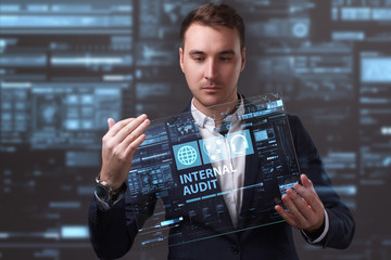 Business, Technology, Internet and network concept. Young businessman working on a virtual screen of the future and sees the inscription: Internal audit