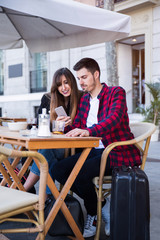 young couple sitting at a terrace