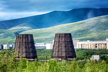 Cooling towers against the background of beautiful mountains and blue sky