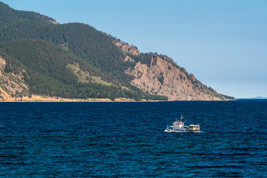 Passenger boat sails on Lake Baikal near Sibiryakov cape