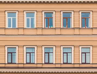 Several windows in a row on facade of urban office building front view, St. Petersburg, Russia