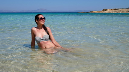 Europe's Secret Islands/ Woman sitting in the water in the sea.