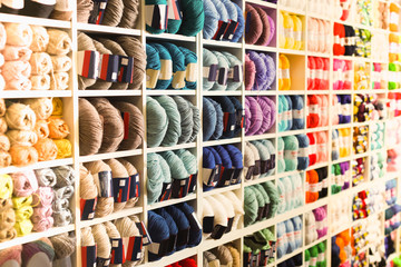 Fototapeta premium Variegated yarns for knitting on shop shelf