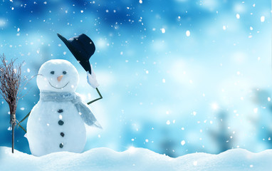 New year greeting card with copy-space.Happy snowman standing in christmas landscape.Snow background