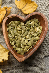 pumpkin seeds in a wooden bowl