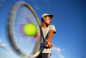 Young men player tennis With sky blue