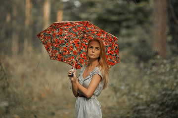 Girl under umbrella in cloudy weather