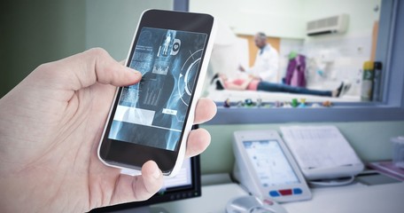 Composite image of cropped hand of man using smartphone