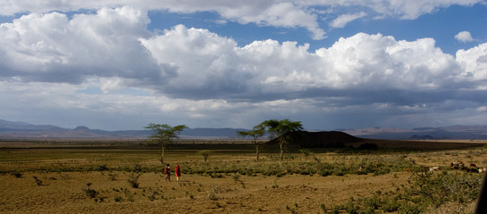 Panorama of the Masai Mara Highlands with some human figures in the distance
