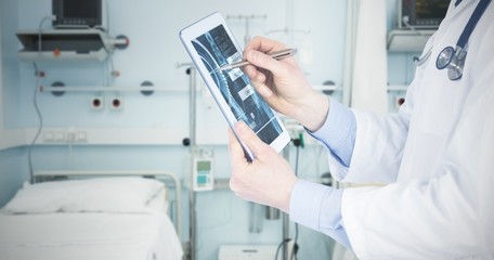 Composite image of doctor scrolling on a digital tablet