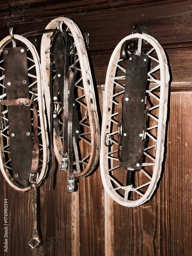 Vintage Wooden Snowshoes Hanging On The Wall In Mountain Cottage Vintage Wooden Snowshoes Hanging On The Wall In Mountain Cottage