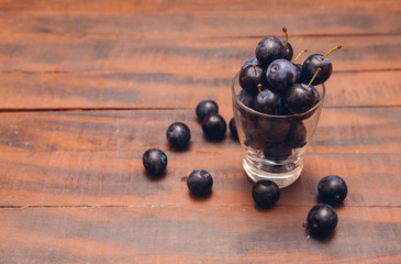 black cherry plum on wooden background