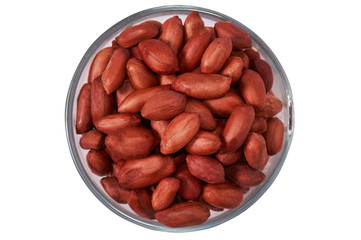 Peanuts in a glass bowl on a white background isolate. View from above.
