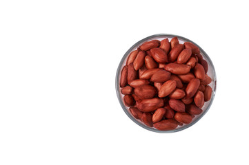 Peanuts in a glass bowl on a white background isolate. View from above.