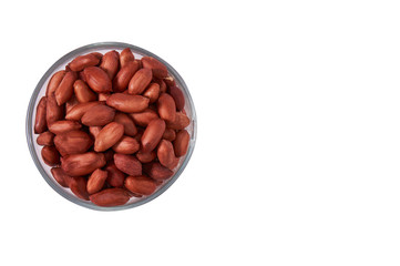 Peanuts in a glass bowl on a white background isolate. View from above.