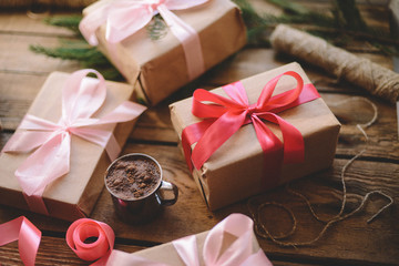 Lots of Gift boxes on wooden background. Presents in craft  paper decorated with  ribbon. Christmas and other holidays concept.