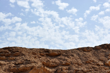Rock and blue sky with clouds