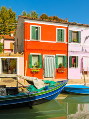 Fototapeta na wymiar Burano Island, colorful houses and boats on channels of island. Venice, Italy