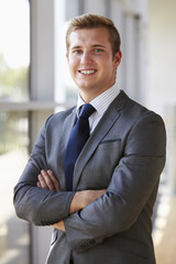 Portrait of a young smiling professional man, arms crossed