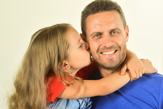 Daughter and father hug each other. Schoolgirl kisses her dad
