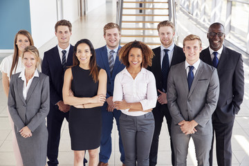 Office workers in a modern lobby, group portrait