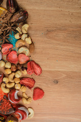 Chocolate sweets with orange slices and dried fruits on a wooden table. handmade?