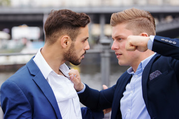two businessmen having a fight outside