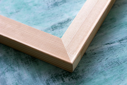 The angle of the subframe on a blue background. Wooden stretcher bars.