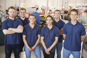 Apprentice engineers in their workplace, group portrait - obrazy, fototapety, plakaty