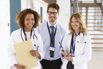 Fototapeta premium Portrait of three male and female doctors, looking to camera